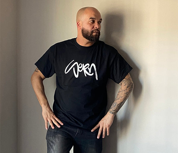 Man with tattoos wearing black SeRn t-shirt